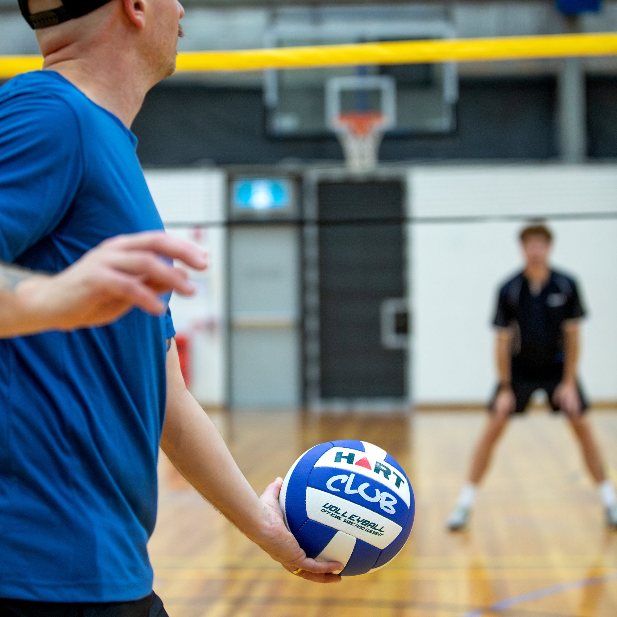 HART Club Volleyball with orange and white panel design, showing a standard size volleyball used for indoor volleyball games.