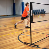 HART Sport rolling badminton net system with sturdy posts and net, designed for easy setup and portable use.