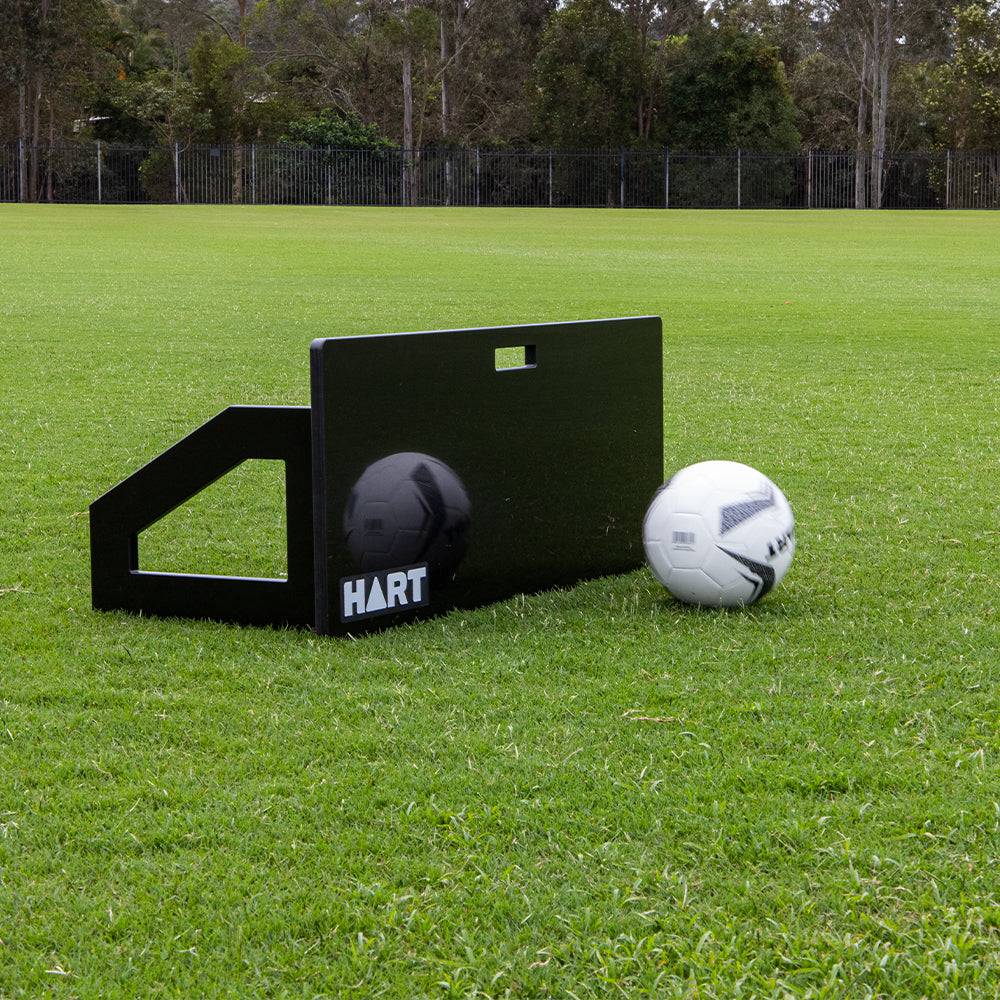 HART soccer rebound board for training, featuring a sturdy design with a large surface for practicing soccer ball control.