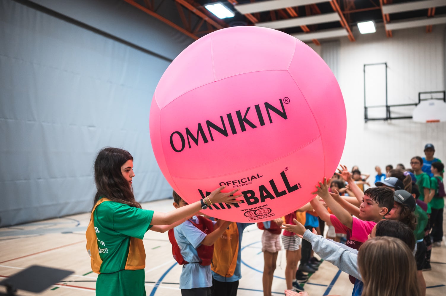 Pink HART KIN-BALL fun ball in a corridor, showcasing its bright color and large size for energetic gameplay.