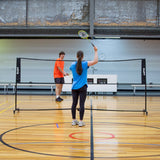 HART Sport rolling net system for badminton with sturdy posts and net, portable design for easy setup and storage.