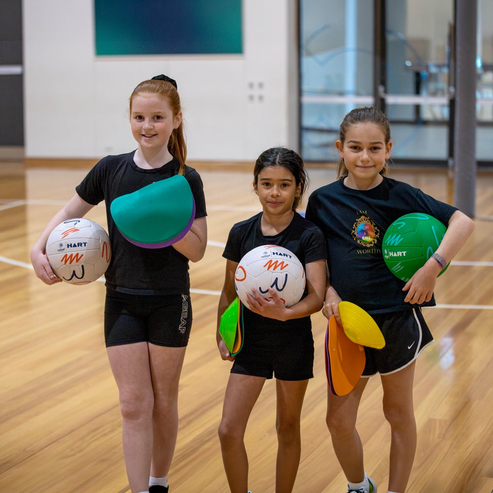 HART Netball Schools Secondary Starter Pack with netball accessories, including balls and training gear for beginner players.