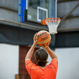 HART 7000 Super Basketball showing orange rubber surface and black textured grip for outdoor play.