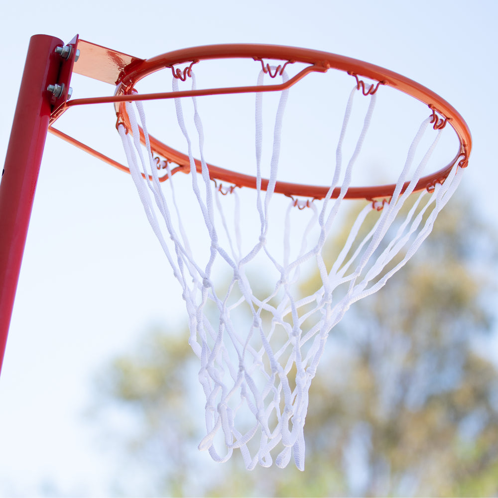 HART base netball post with sturdy metal pole and adjustable height, suitable for outdoor netball courts.