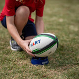 HART Converter Kicking Tee for football, black rubber with sturdy design, used for practice and game kicking drills.