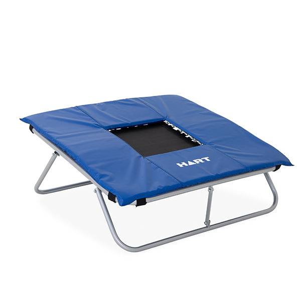 HART Mini Trampoline with safety pad for indoor use, featuring a sturdy frame and cushioned jumping surface.