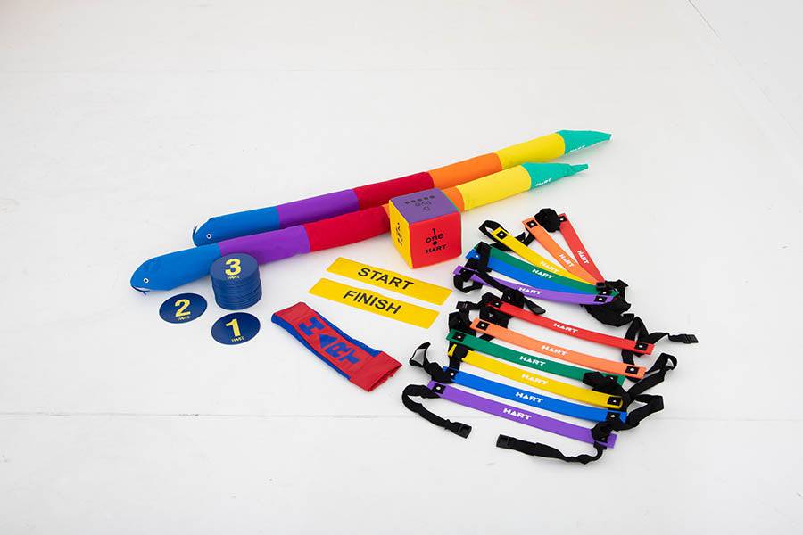 HART Snakes and Ladders game kit with colorful game board, plastic game pieces, and dice for family fun.